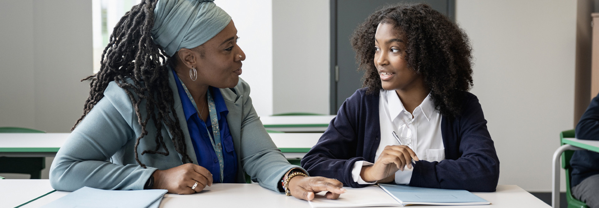 Teacher working closely with student