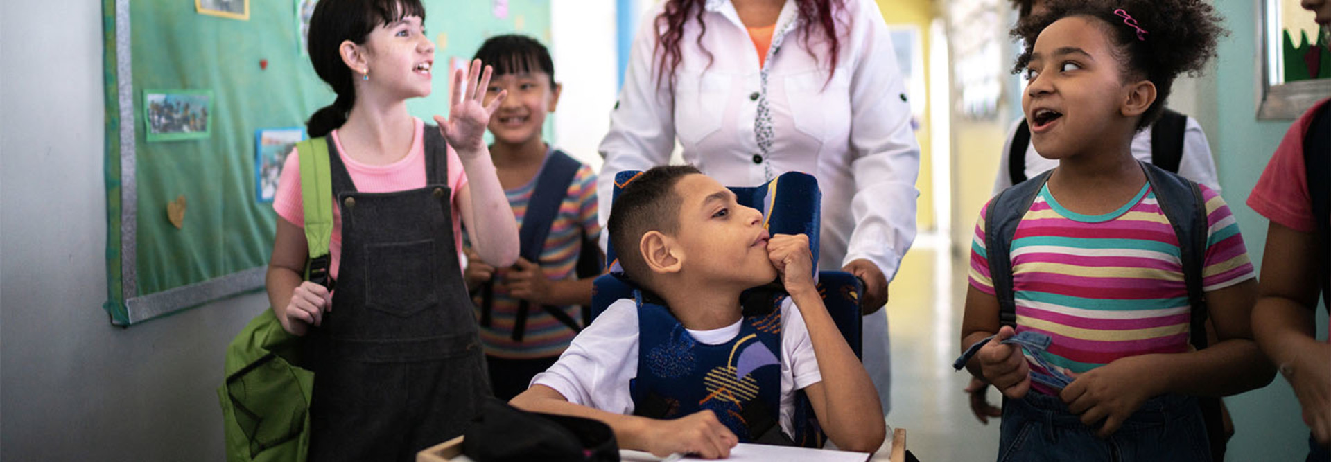 Student in wheelchair interacting with others