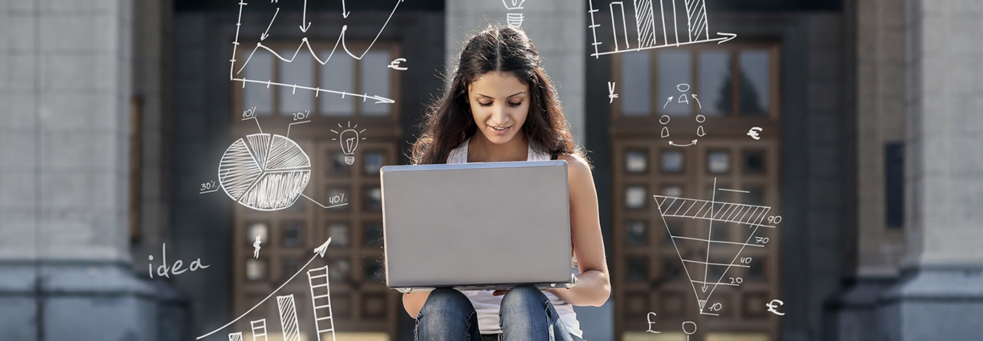 Student working on laptop outside
