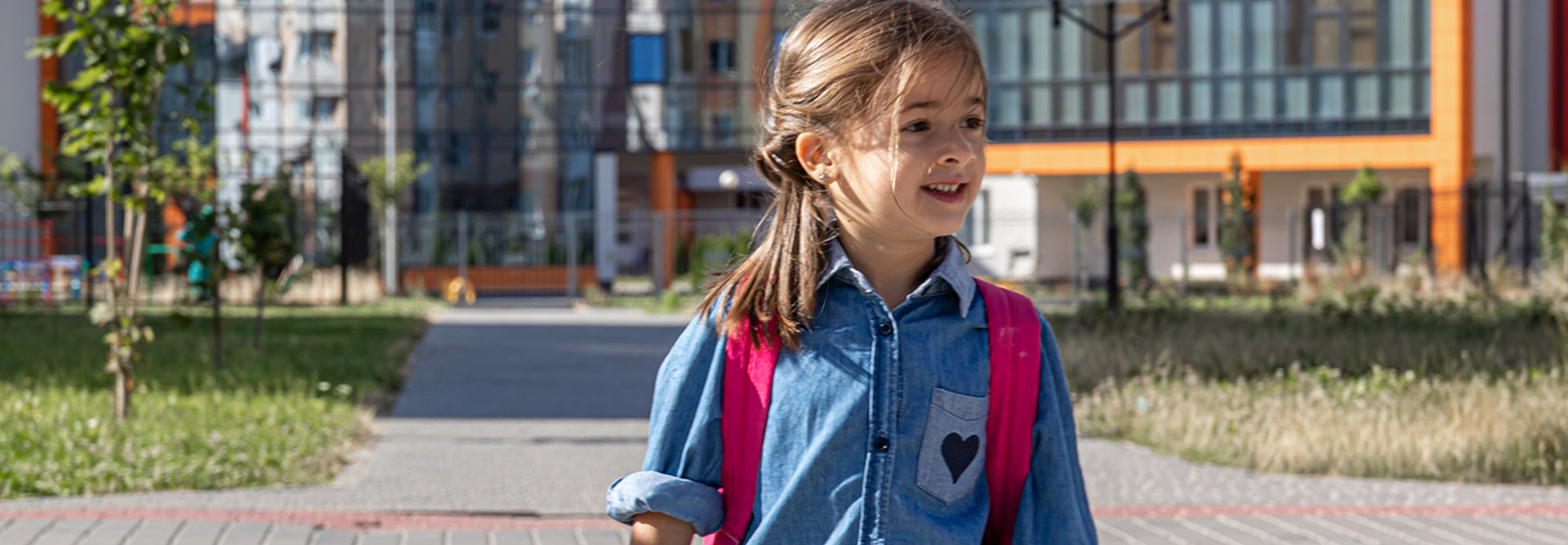 primary school student with a backpack goes home from school