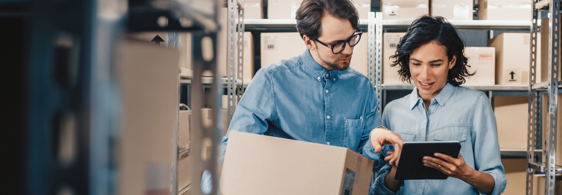 Co-workers using tablet to check inventory