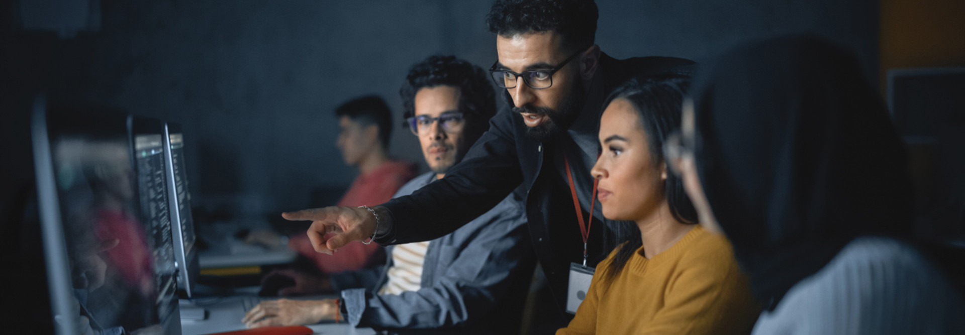 IT leader teaching cybersecurity to adults with computers