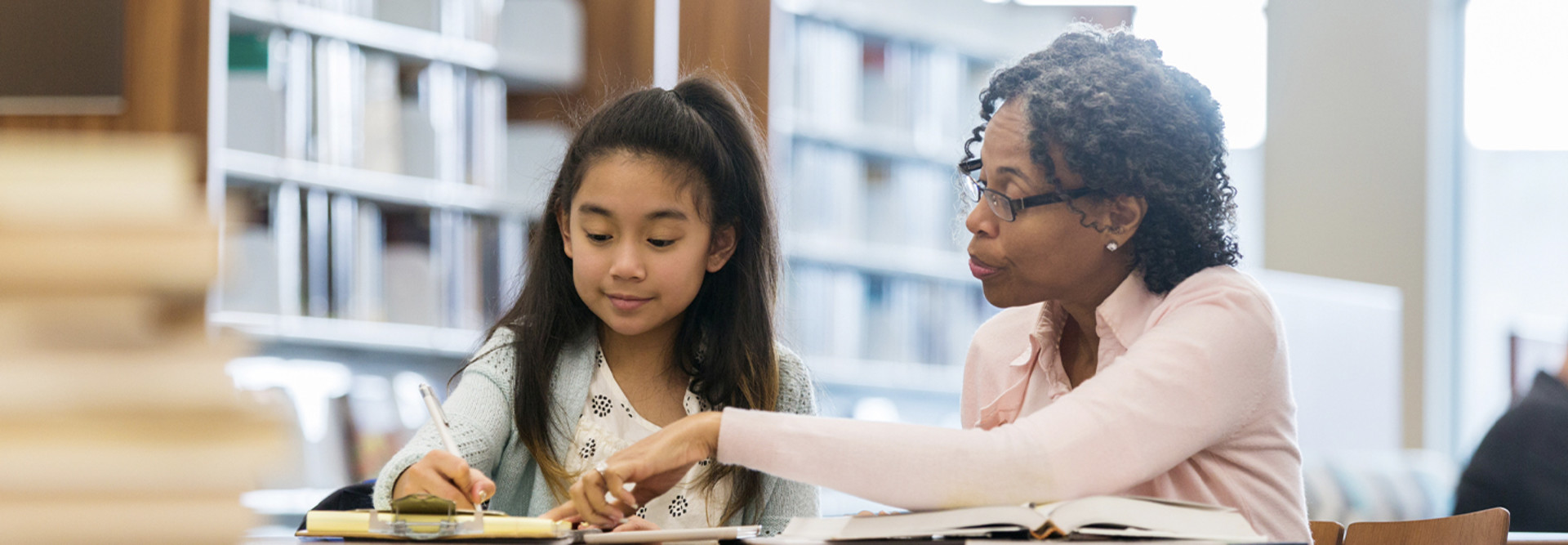 Teacher helping student