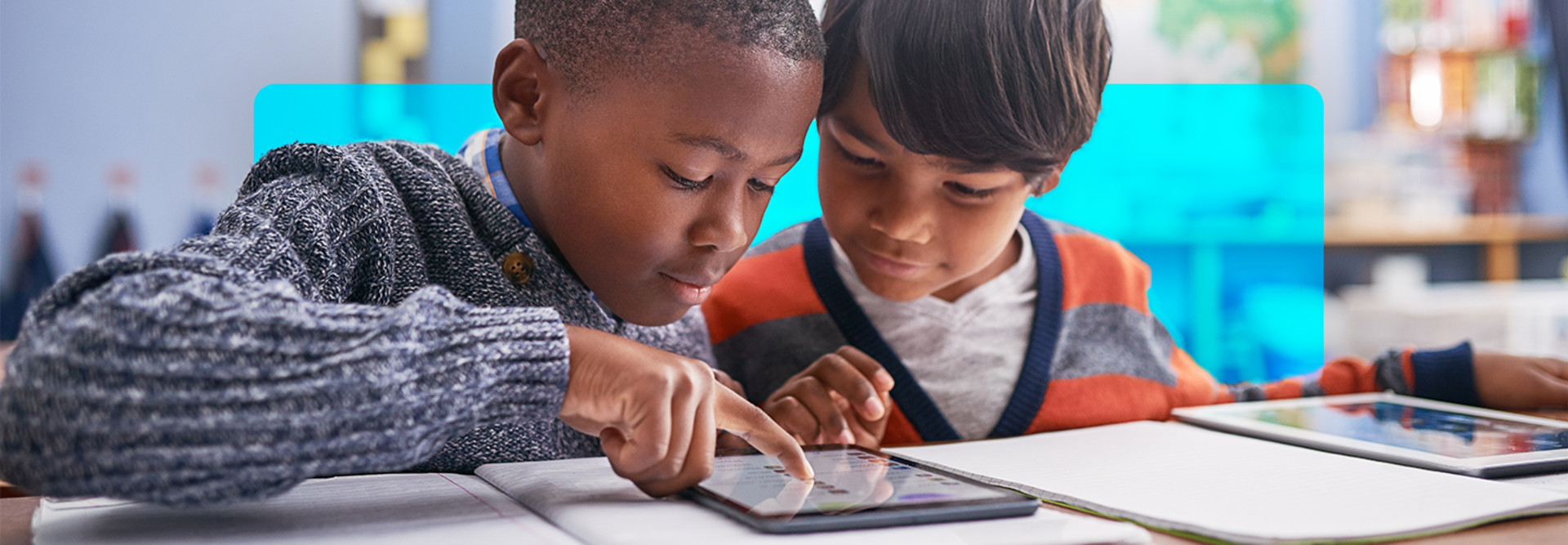 k12 students working together on tablet thanks to strong network