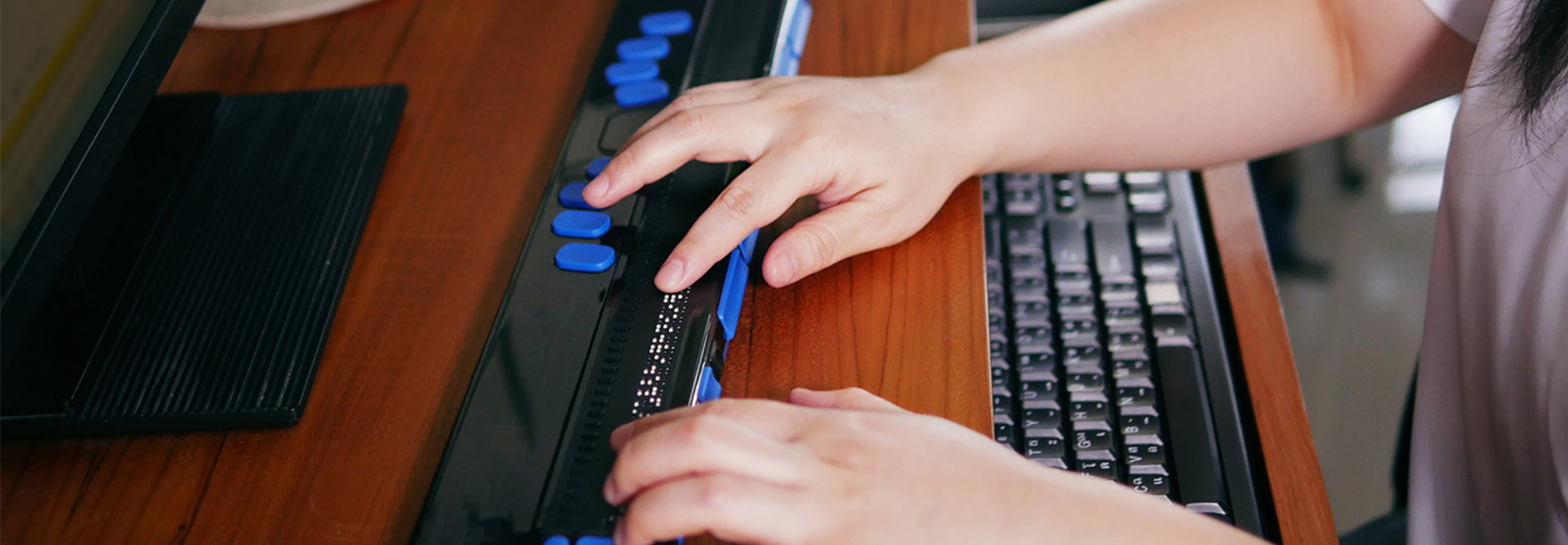 Blind student using braille technology