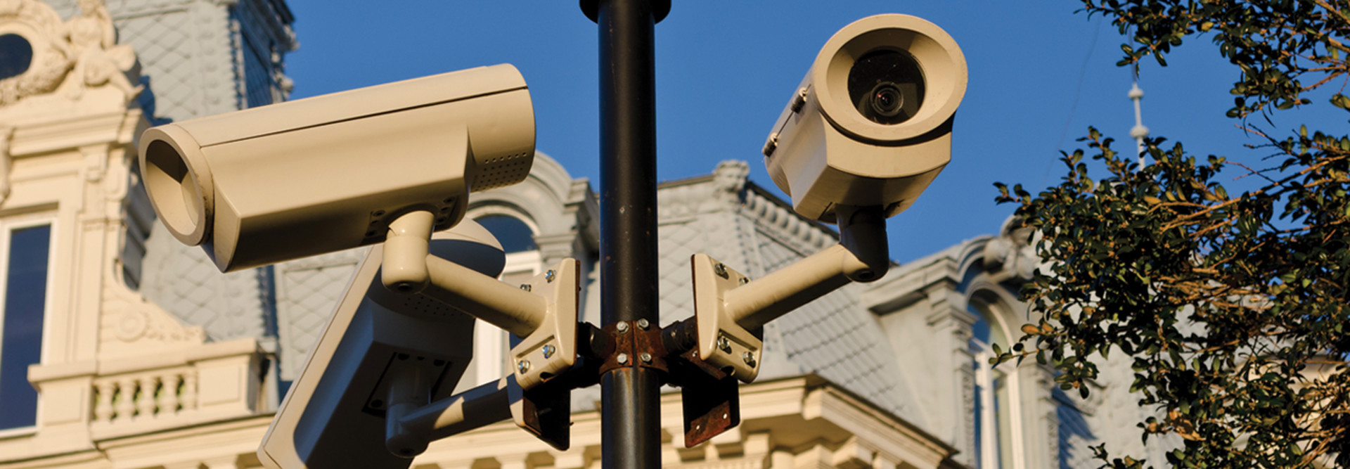 Security cameras installed on pole in front of historic building