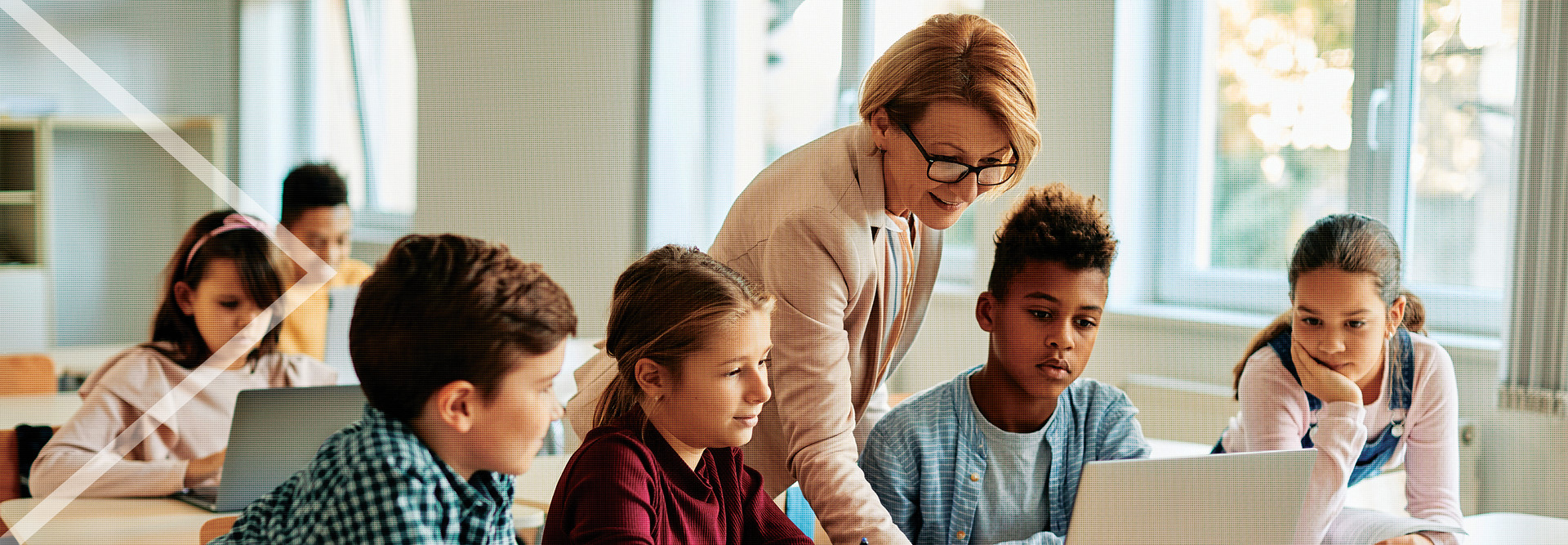 Teacher assisting students in the classroom