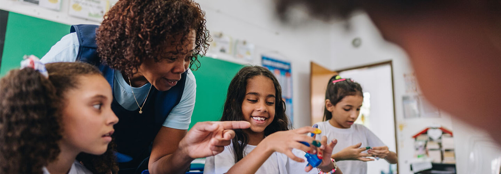 Teacher helping students during art class