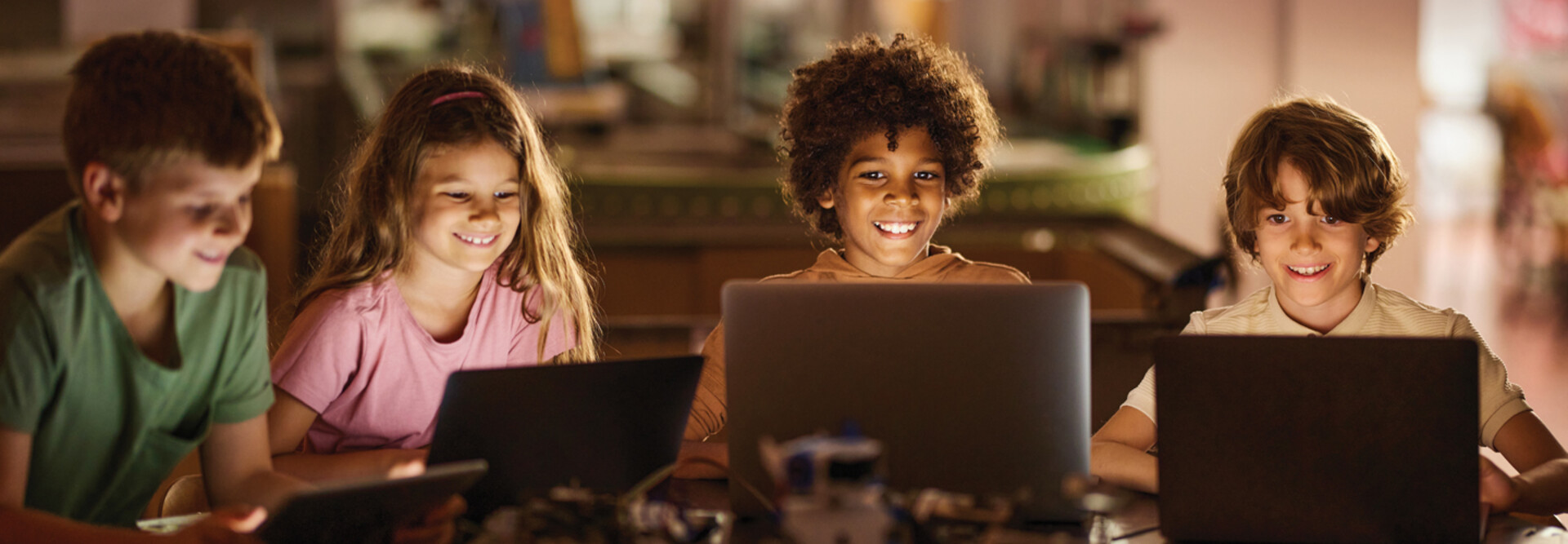 Students learning on laptop computers in a K12 classroom