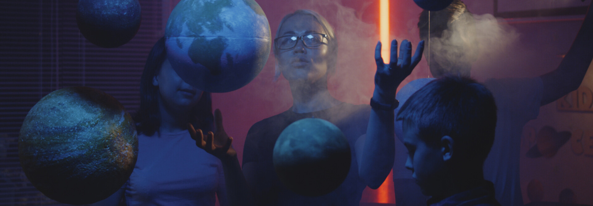 Teacher teaching astronomy with planet models