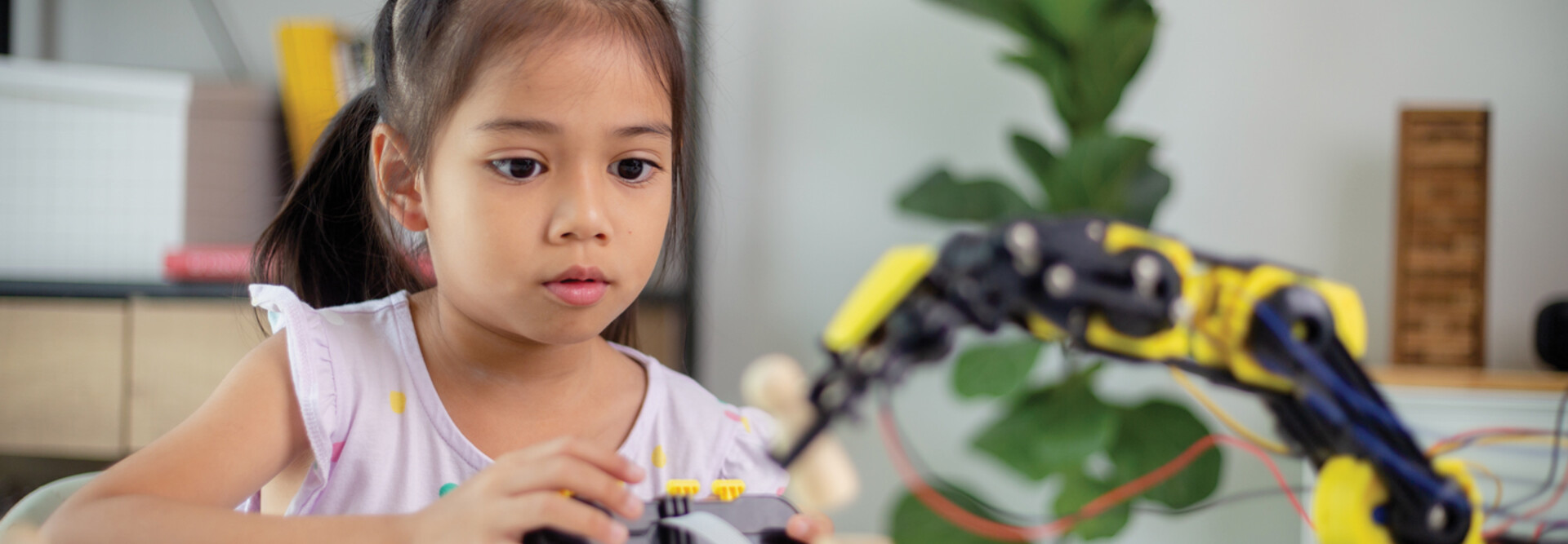 K12 student working on steam project with robot