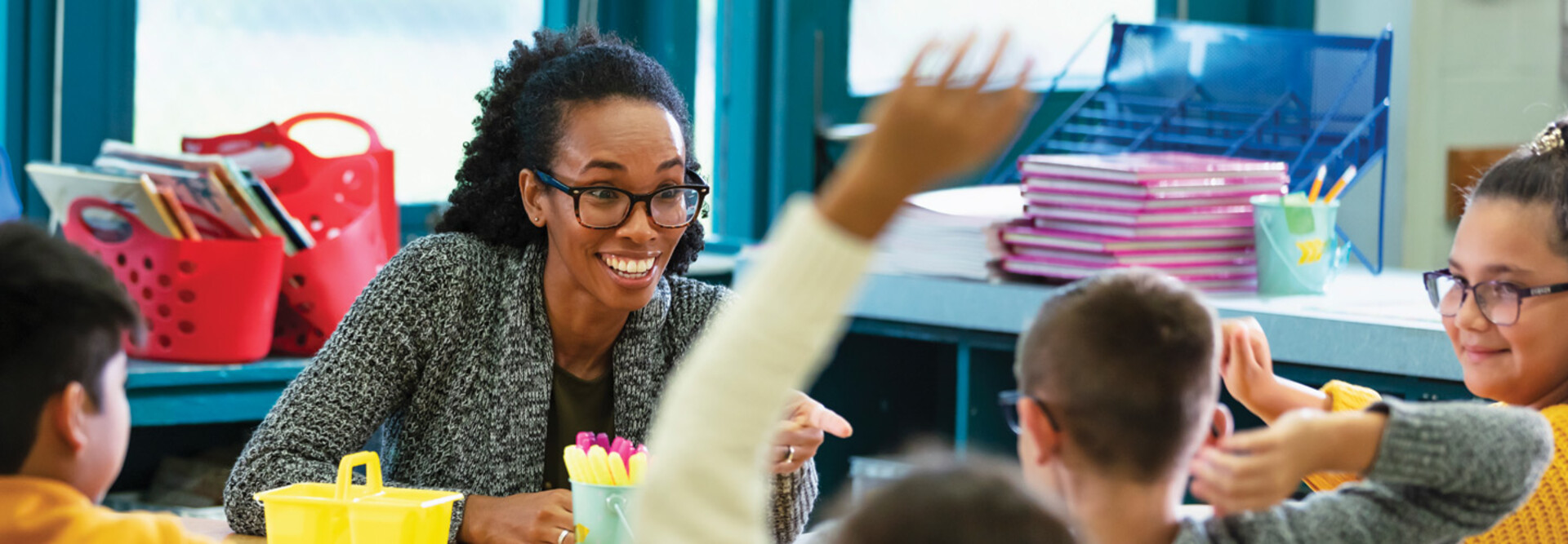 K12 teacher interacting with students in classroom