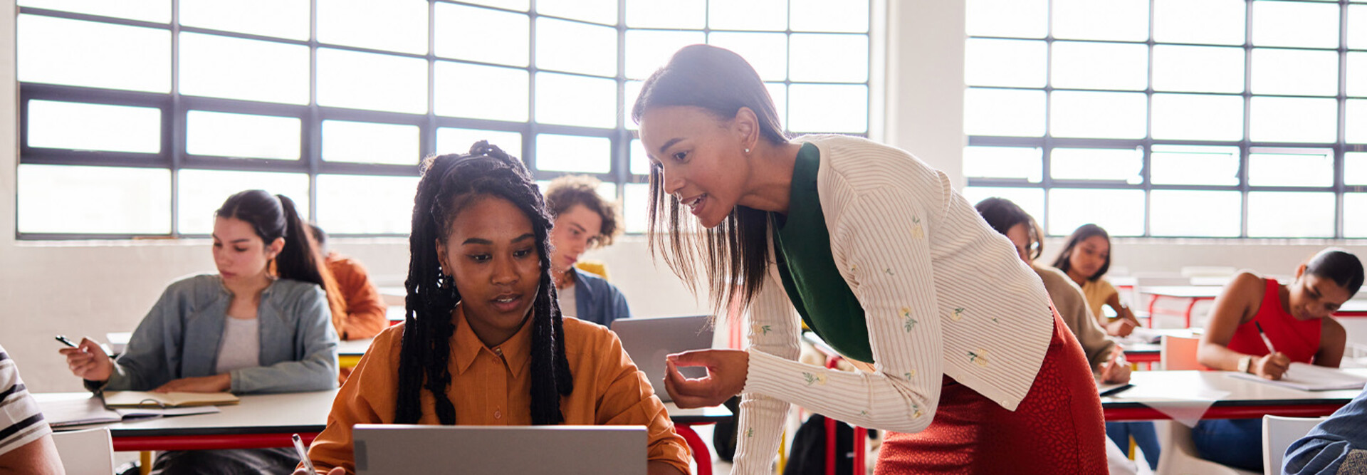 Teacher helping student in class