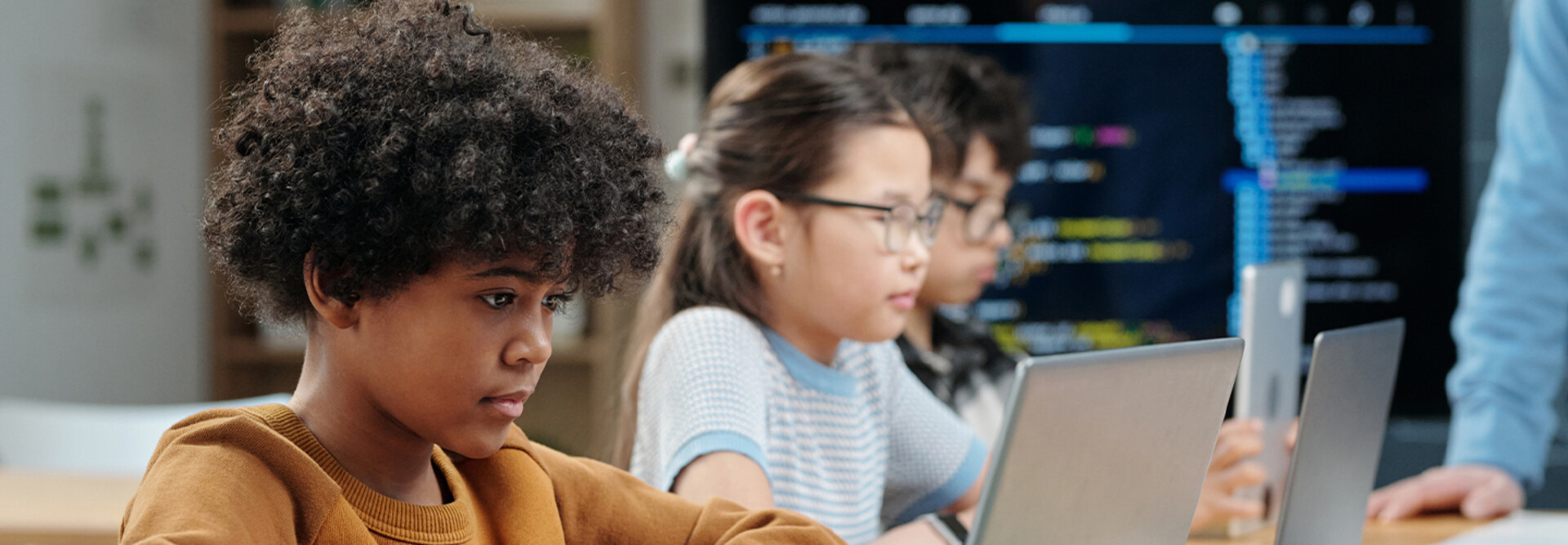 Students using laptops in school
