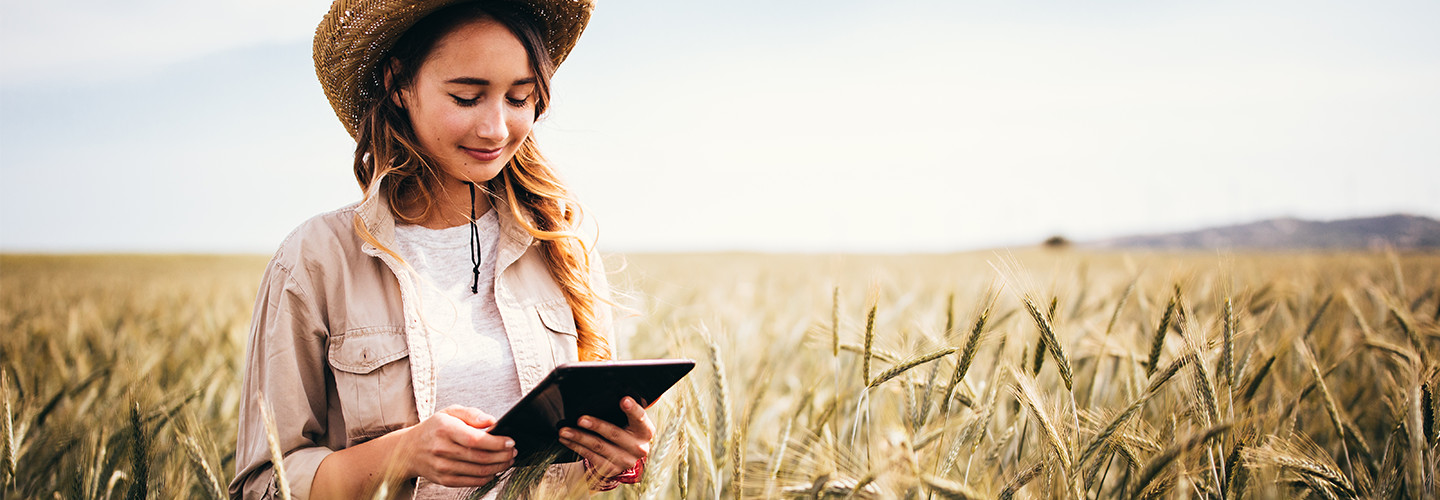 Girl in field with tablet