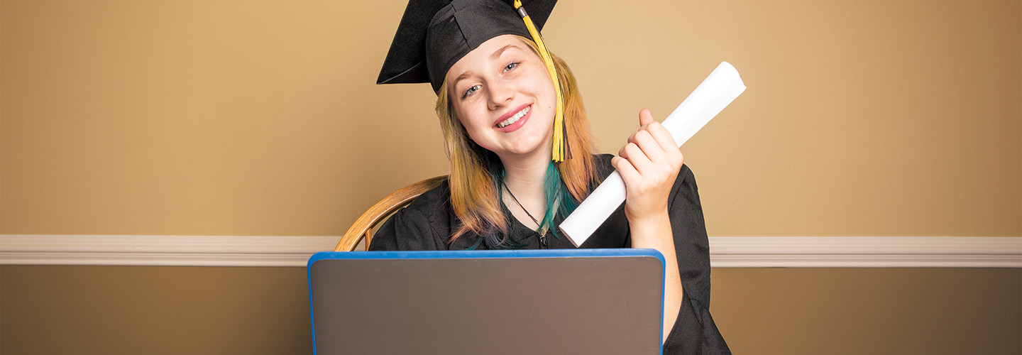 high school girl graduating on her laptop