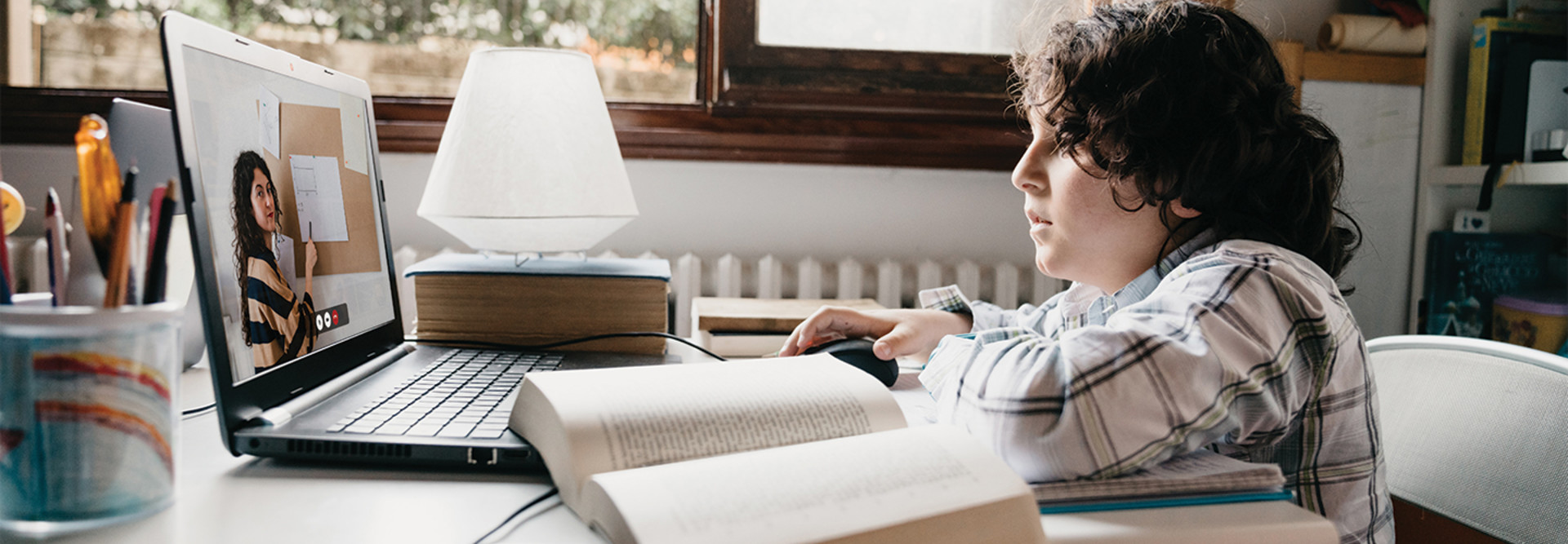 young boy using laptop for remote learning at home
