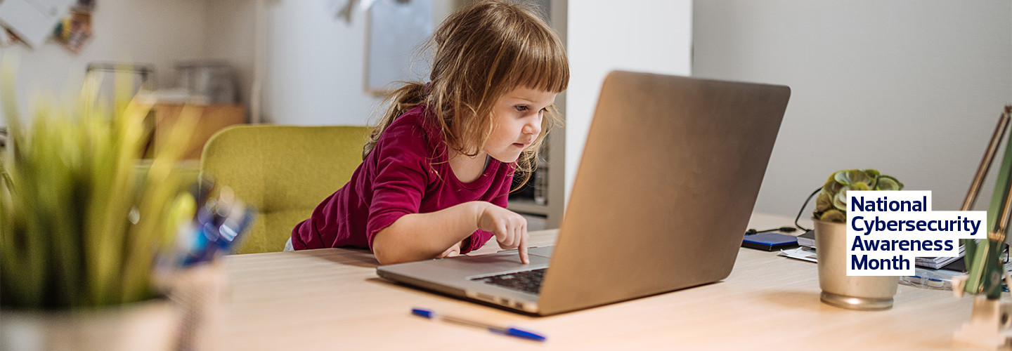 young girl using internet on parent's laptop