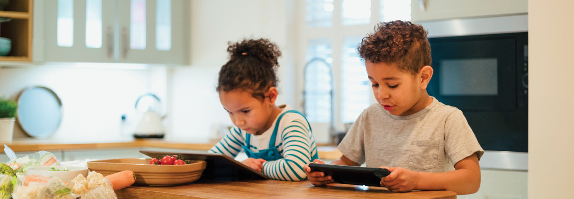 Students remote learning from their kitchen