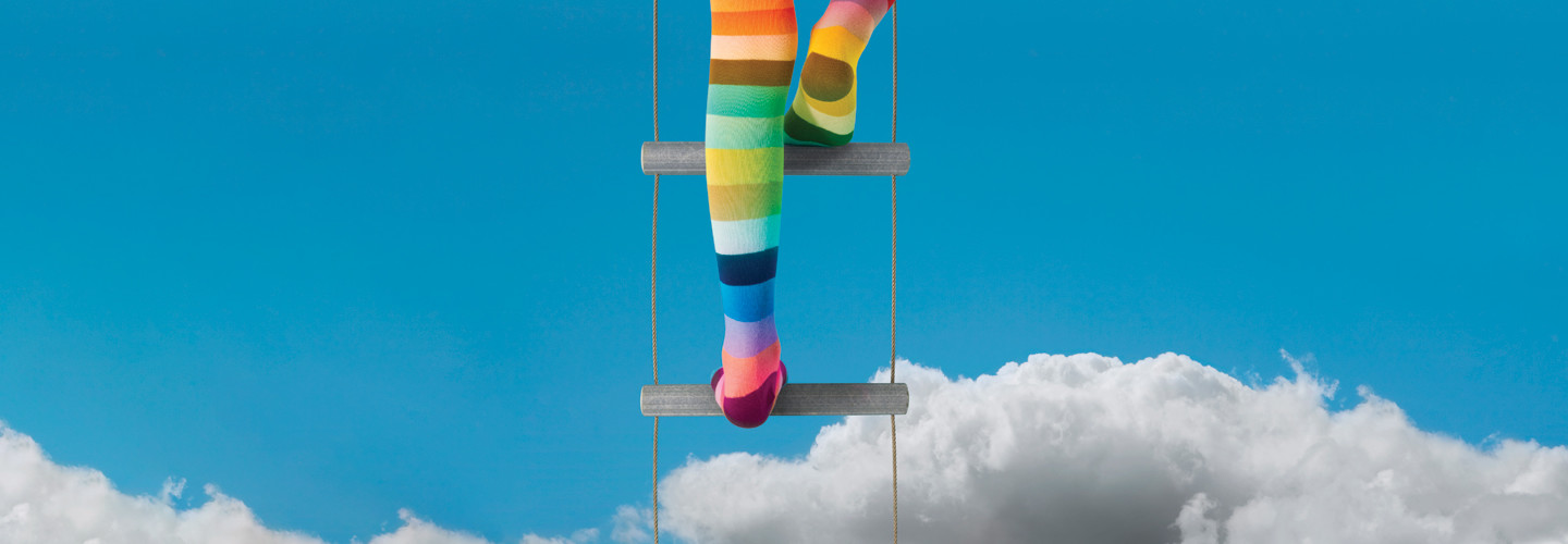 climbing into the cloud with rainbow socks on to represent elevated tech