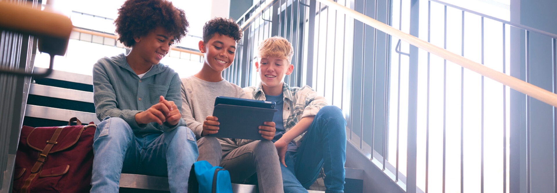 K12 students using tablet on school stairwell with great wi-fi