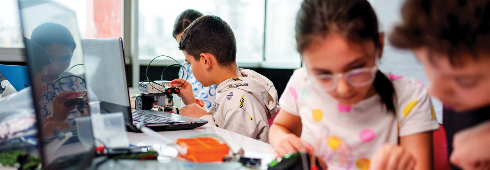 A group of children work together on some type of technology project