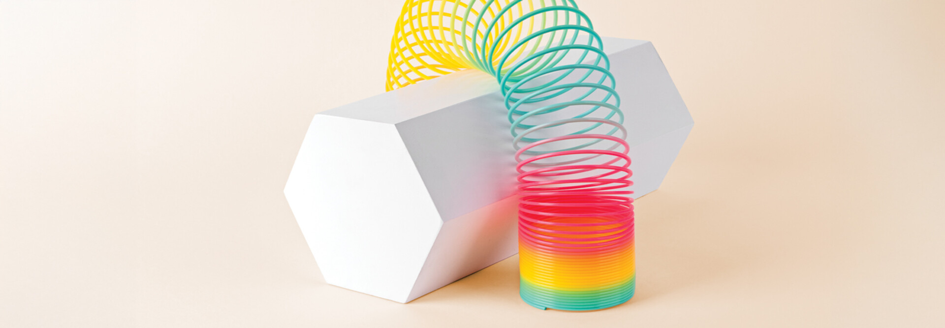 Flexible Multi Colored Coil Striding Hexagon Shape on White Background