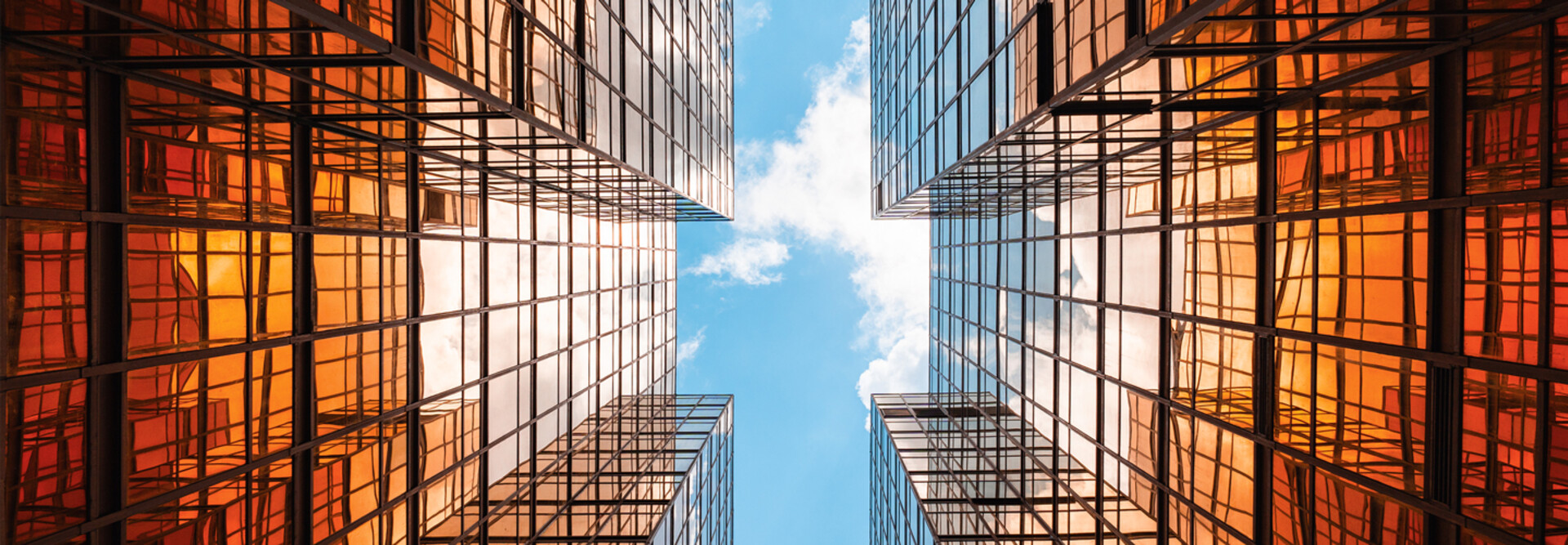 Digital twins concept showing the sky between two glass buildings