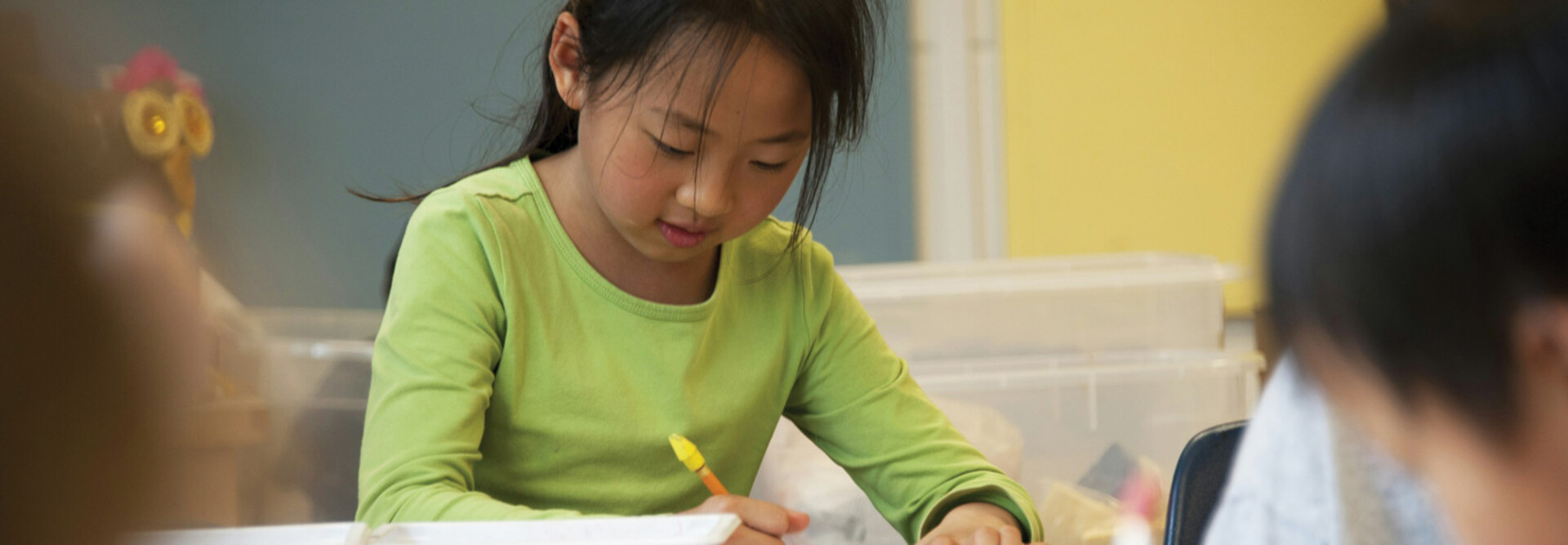 A K-12 student focusing and working on a creative makerspace project