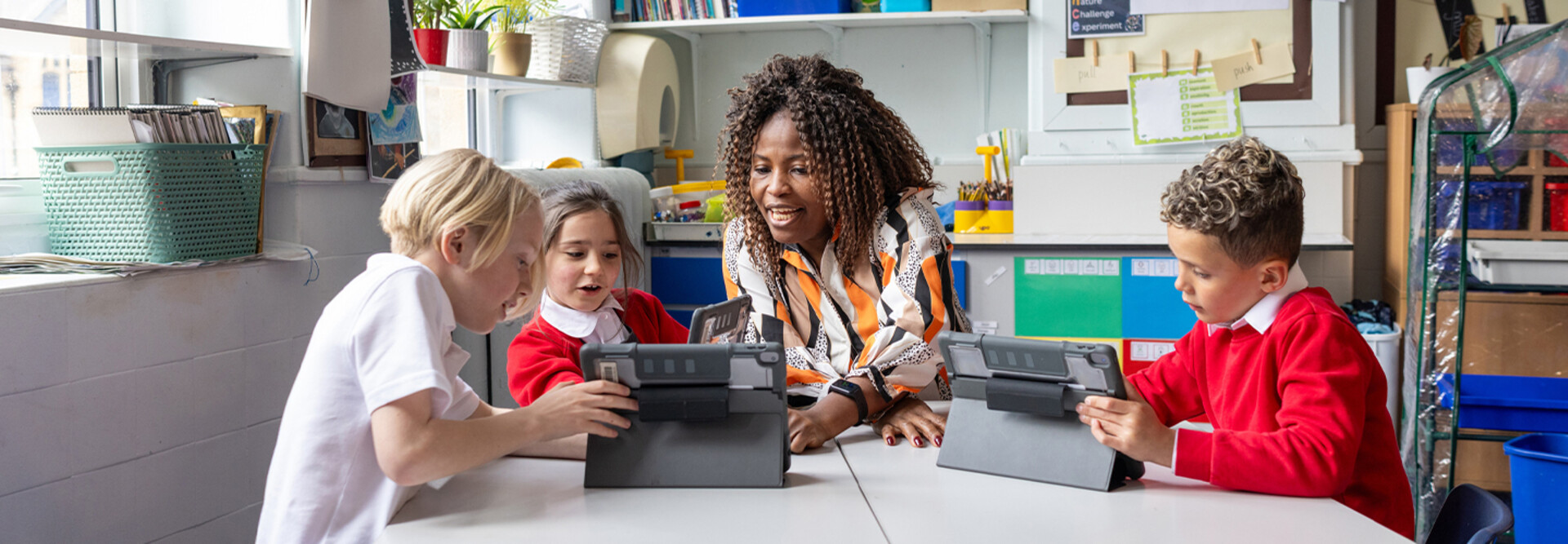 Teacher helping students with tech