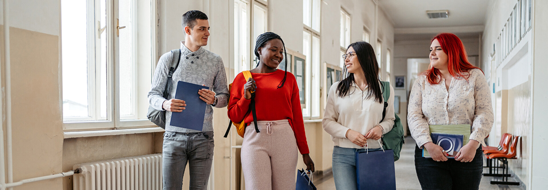 Students walking down the hall and talking.