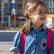 primary school student with a backpack goes home from school