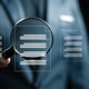 managed detection magnifying glass looking at documents