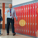 Two adults walking in school hallway talking about app modernization