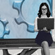 Person using laptop with gears in the background