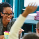 K12 teacher interacting with students in classroom