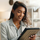 Person using tablet around boxes