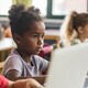 Young students working on laptops in school