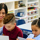 Teacher helping students with tech