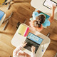 Overhead view of children sitting at desks working in a classroom on computers
