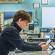 Student in a classroom working on a tablet at a table
