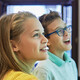students smiling while writing on digital whiteboard