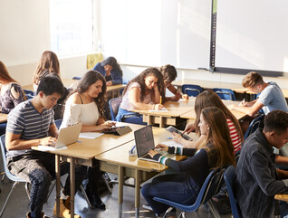 Students working at desks together in a classroom
