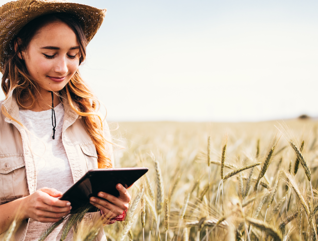 Girl in field with tablet