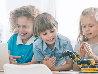 Kids with robot and laptop