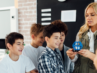 teacher and students with 3D printer