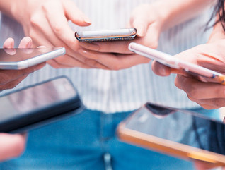 Group of people holding their smartphone and testing a mobile app.