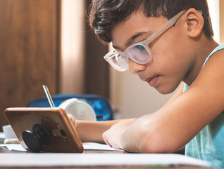 boy using mobile phone for online learning