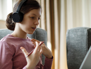 girl with headphones using laptop