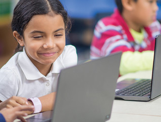 Two kids remote learning on laptops 